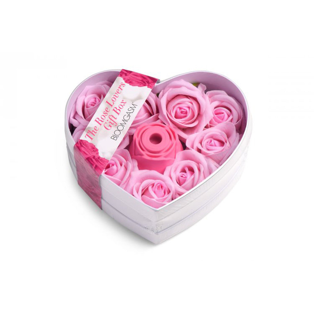 Heart-shaped gift box with pink faux roses and a pink rose toy.