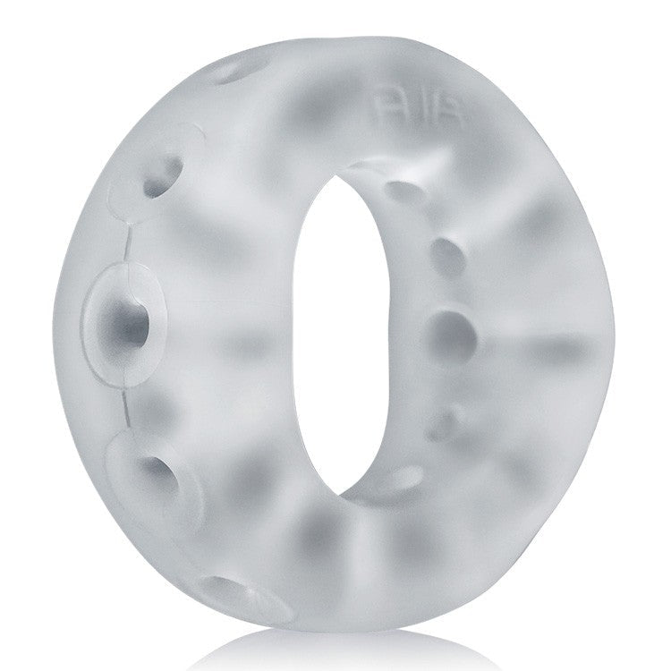 A translucent, flexible silicone ring with multiple holes and raised bumps.