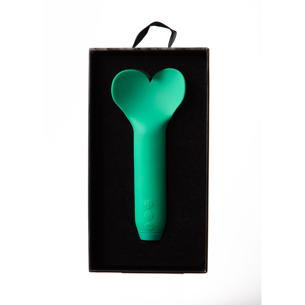 Emerald green heart-shaped vibrator in a black box.
