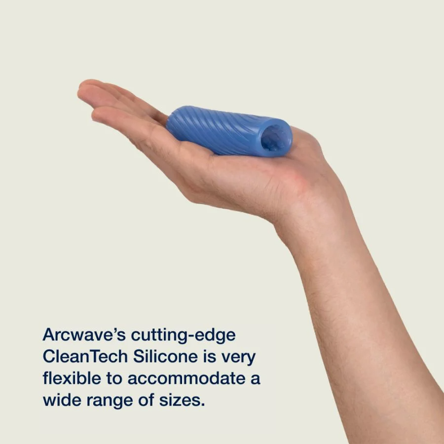 A blue silicone stroker with a textured surface rests in an open palm.