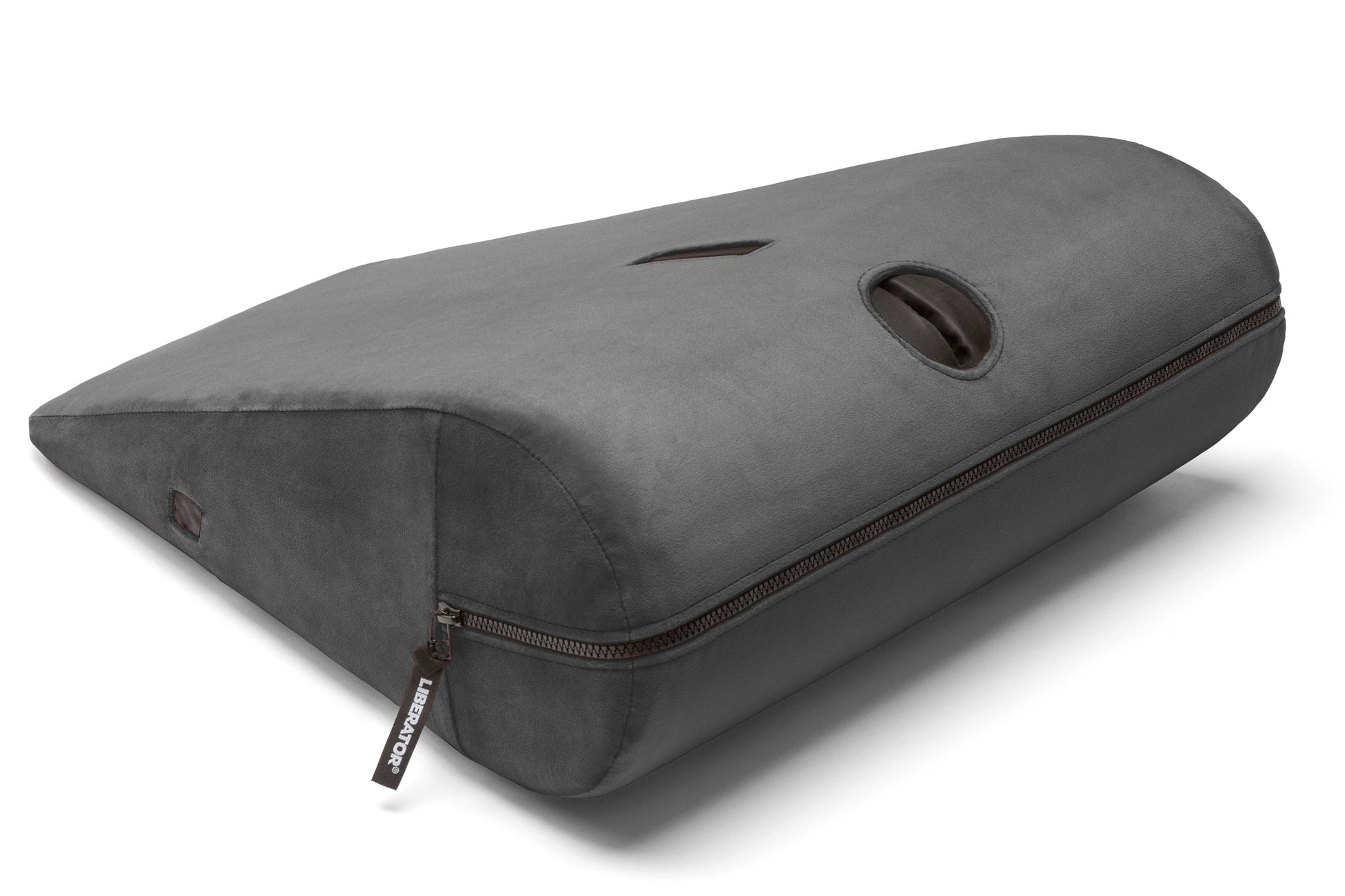 A black velvish positioning pillow with a zipper and a handle.