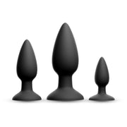 Three black silicone anal plugs of varying sizes.