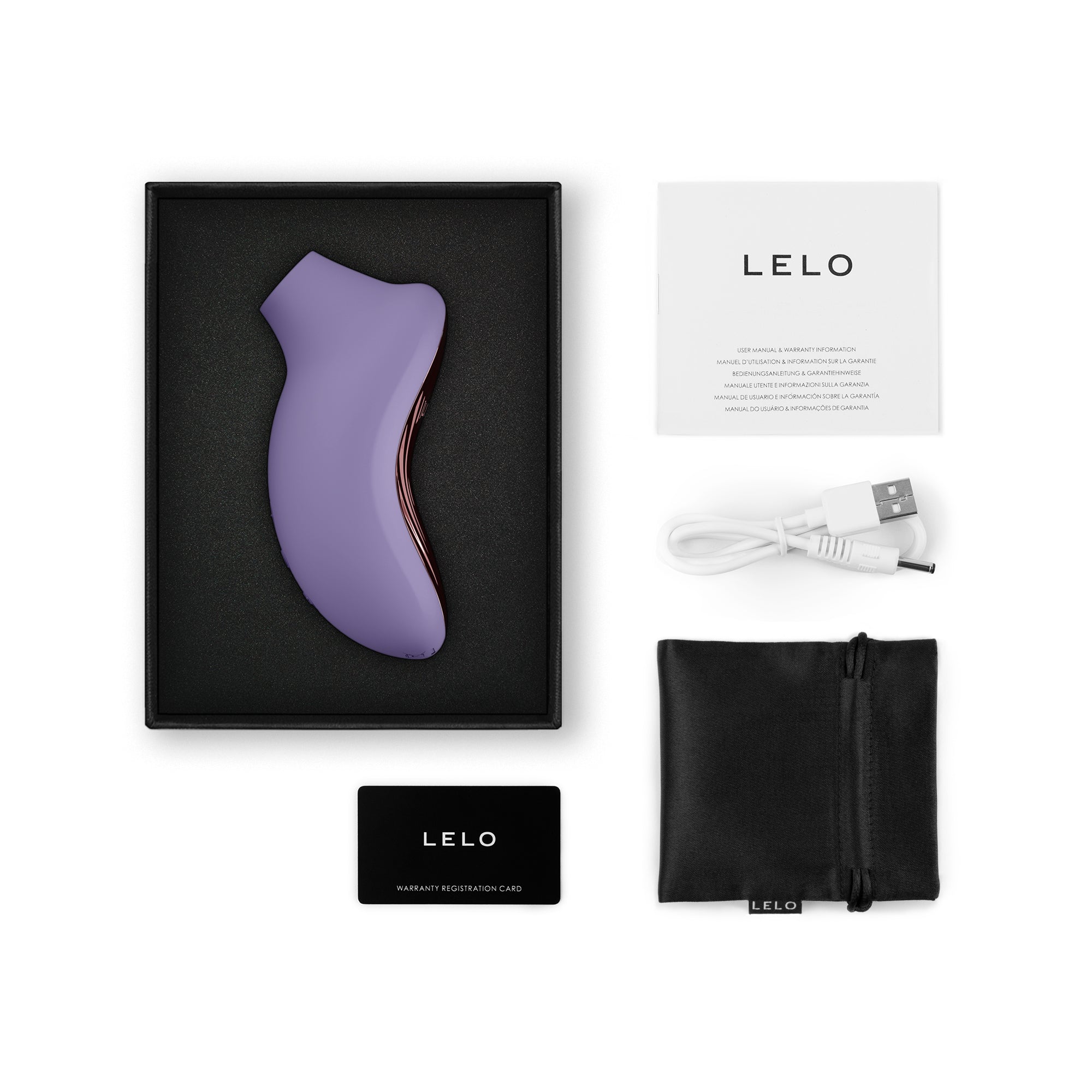 A purple silicone clitoral stimulator with a charging cable, manual, and warranty card.