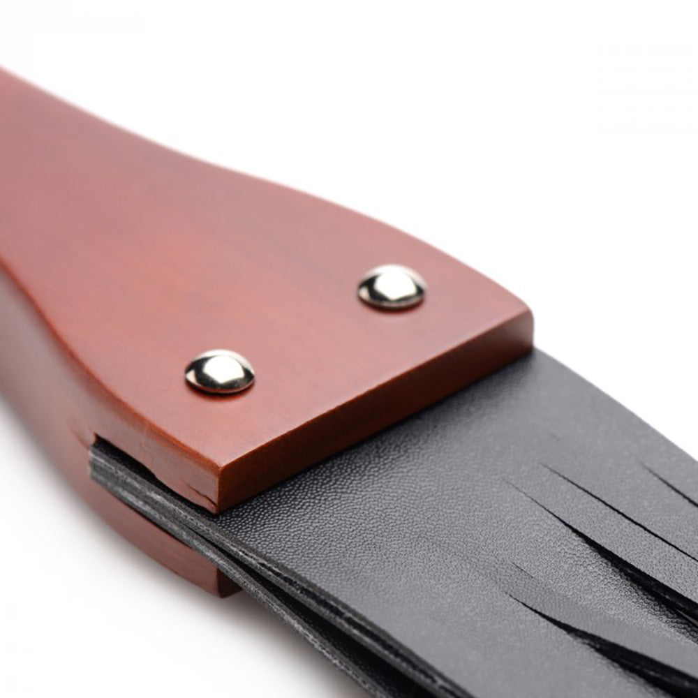 Flogger with ergonomic wood handle and PU leather falls.