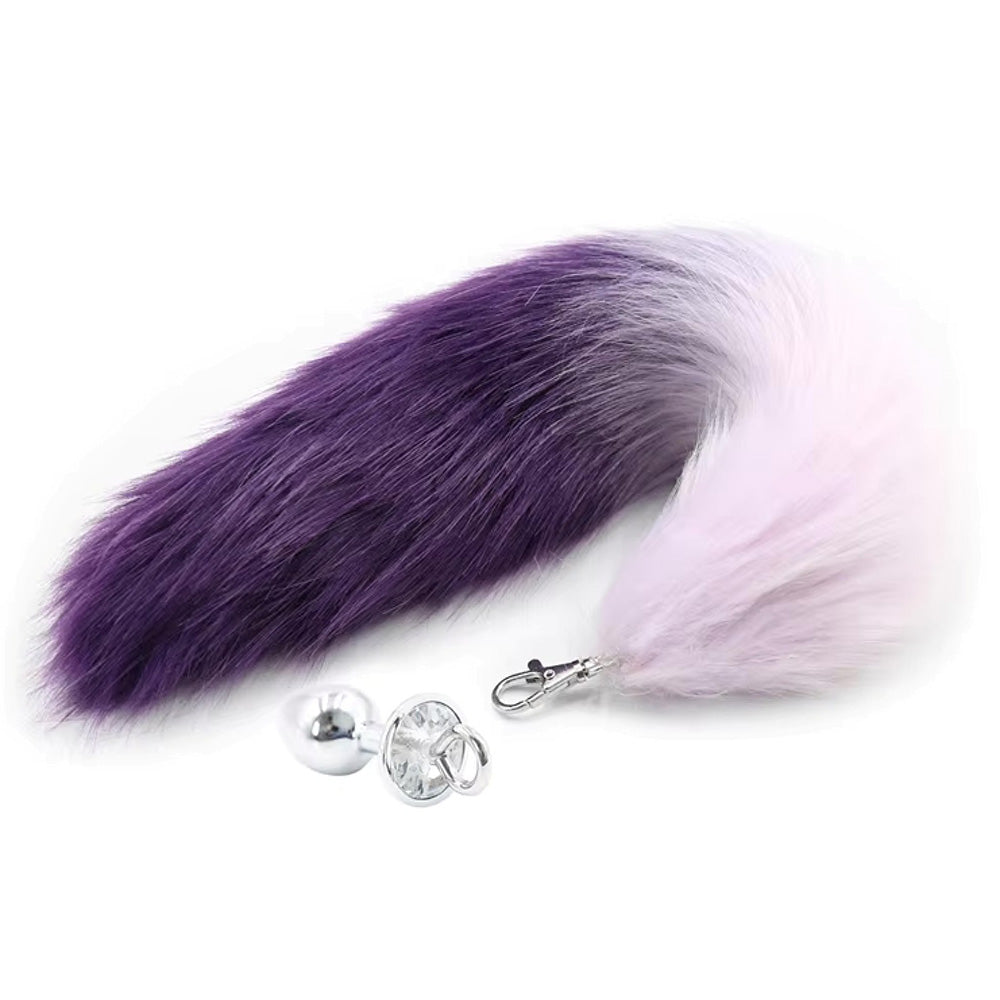 Purple and pink ombre faux fox tail with a silver anal plug.