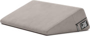 Grey velvet wedge positioning pillow with a zipper and logo.