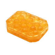 A translucent orange honeycomb-shaped object with a textured surface.