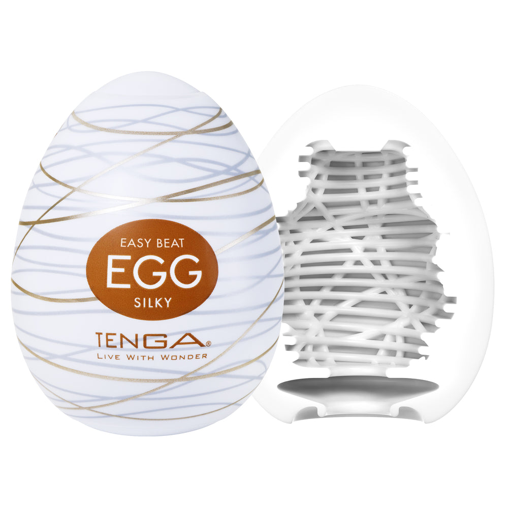 Tenga Silky Male Masturbator Egg with a white exterior and gold lines, showing the textured interior.