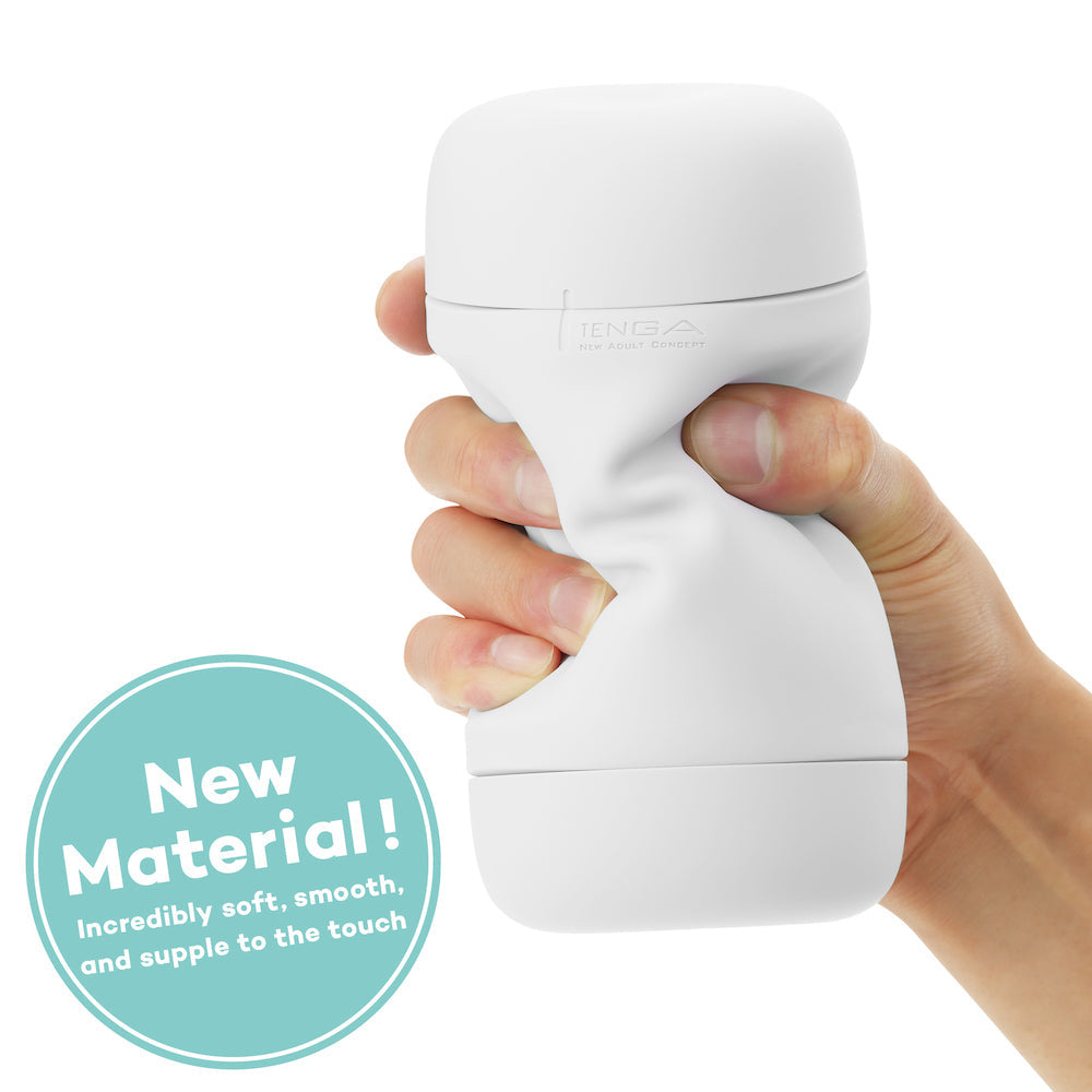 A hand squeezes a white, soft, flexible TENGA stroker.