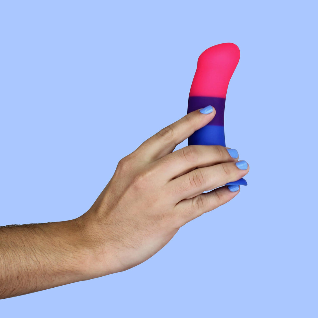 A hand holds a dildo with bisexual pride flag colors.