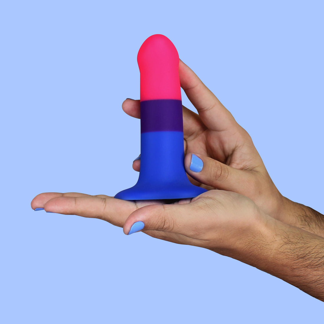 A bisexual pride dildo with pink, purple, and blue stripes.