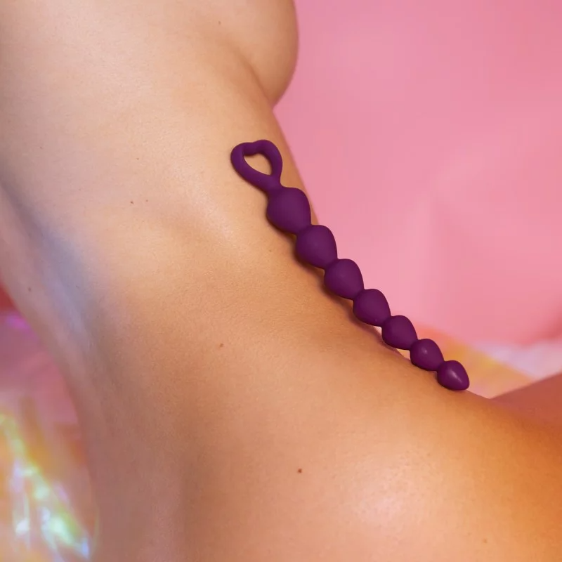 Purple silicone anal bead chain with a heart-shaped handle.