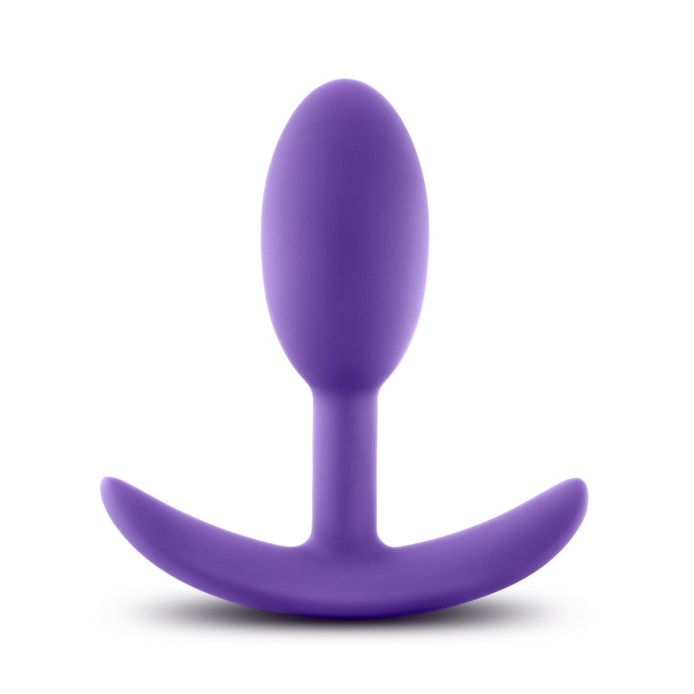 Purple silicone wearable anal plug with a curved base.