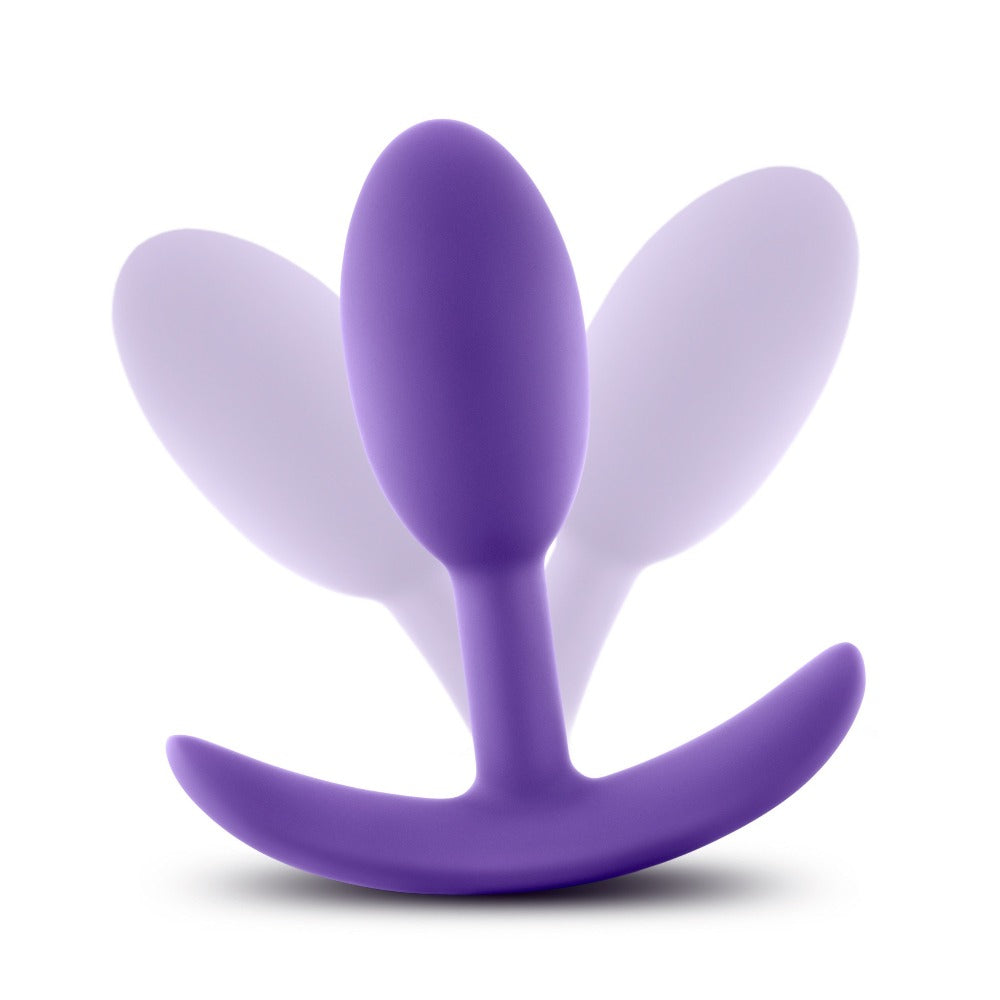 Small purple silicone wearable anal plug with a curved base.