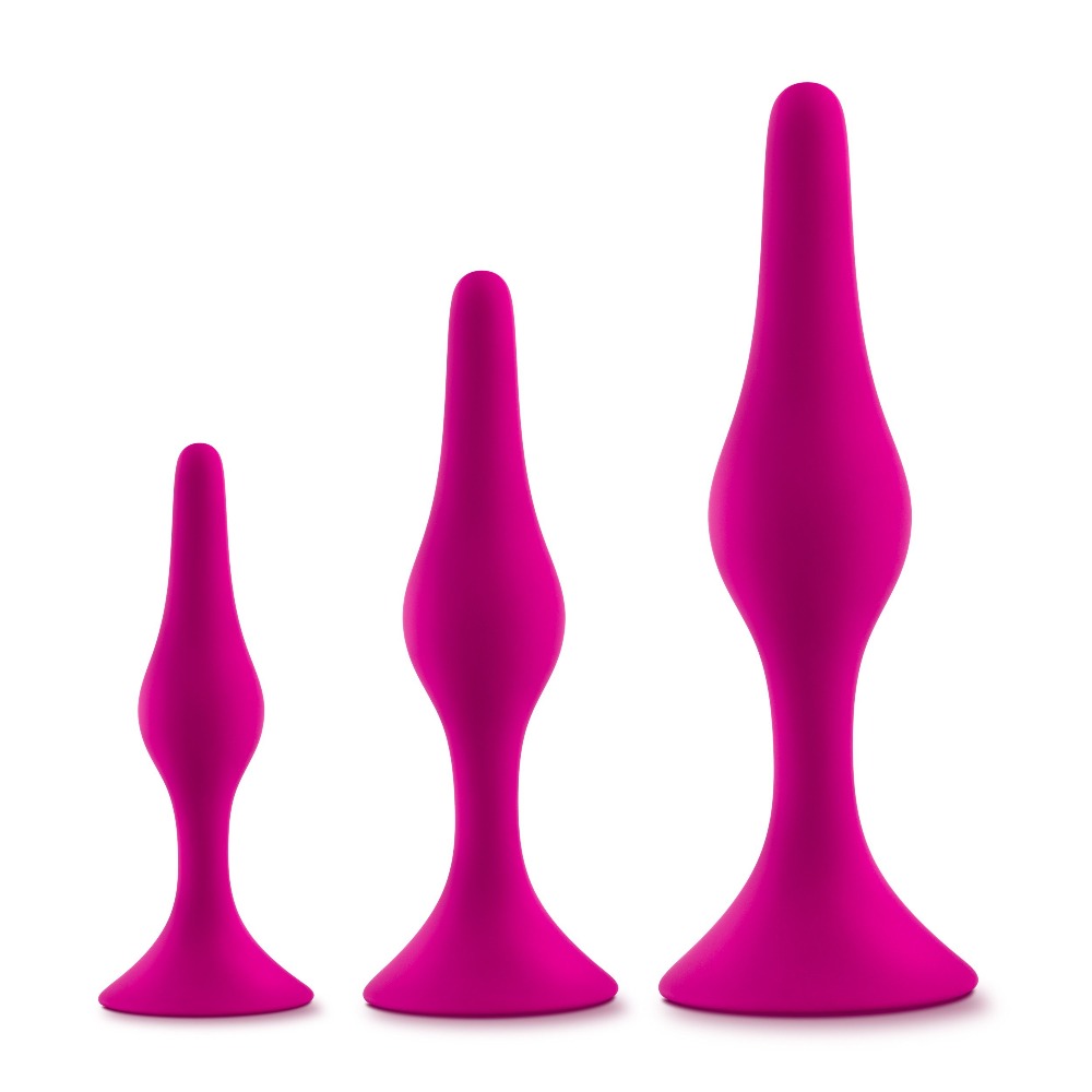 Three pink silicone anal plugs of varying sizes.