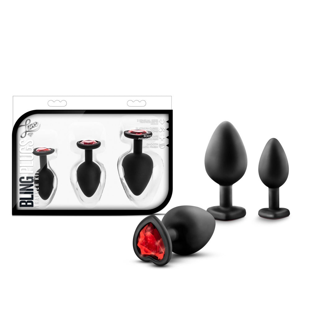 Silicone anal training kit with three black plugs and red heart gems.