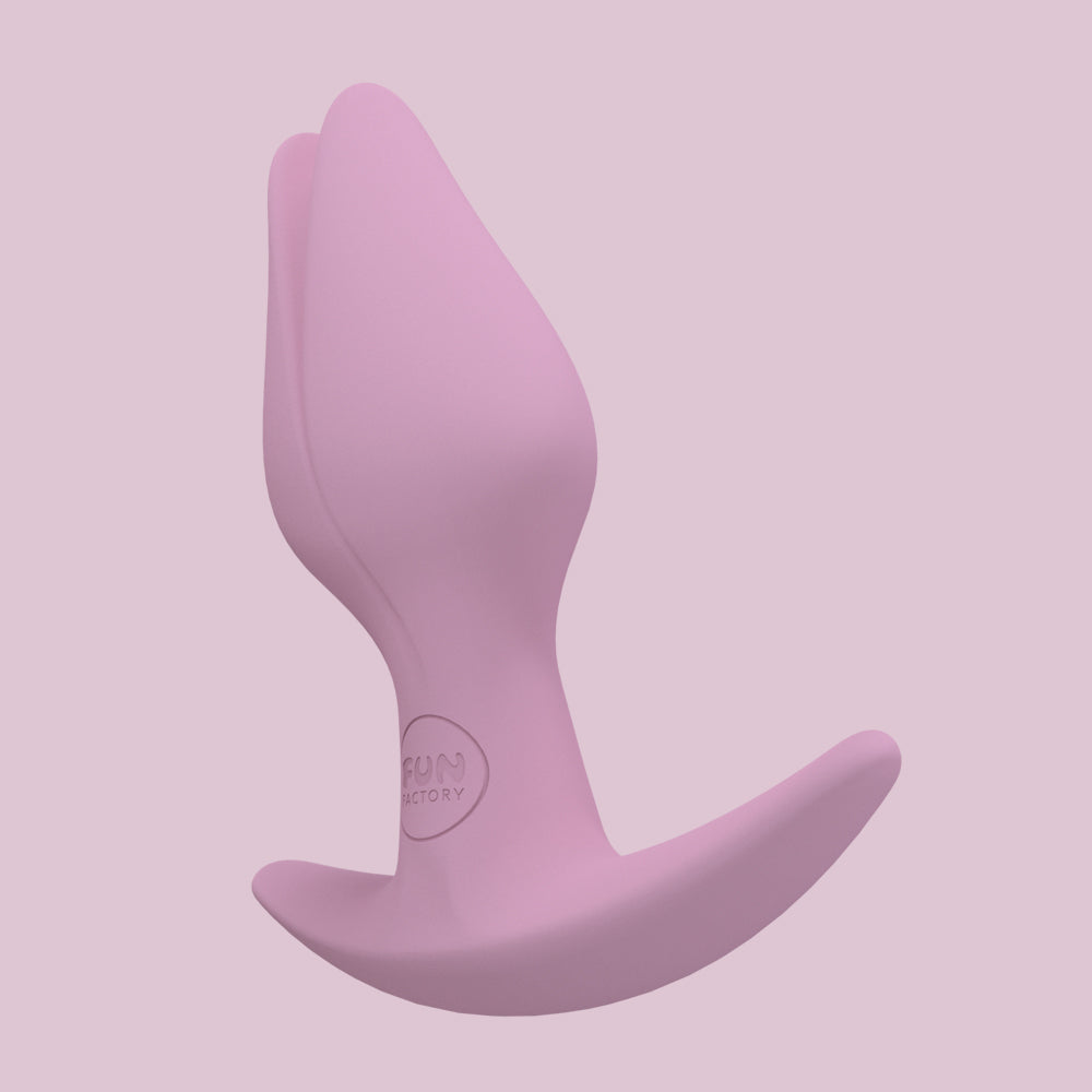 A pink Bootie Slim Anal Plug with an asymmetrical base.