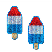 Two glitter ice pop shaped nipple pasties in red, white, and blue.