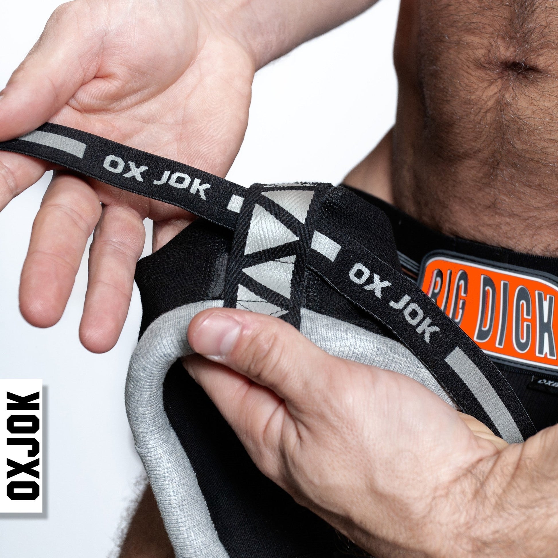Jockstrap with padded pouch, "OX JOK" branding, and a "BIG DICK" patch.