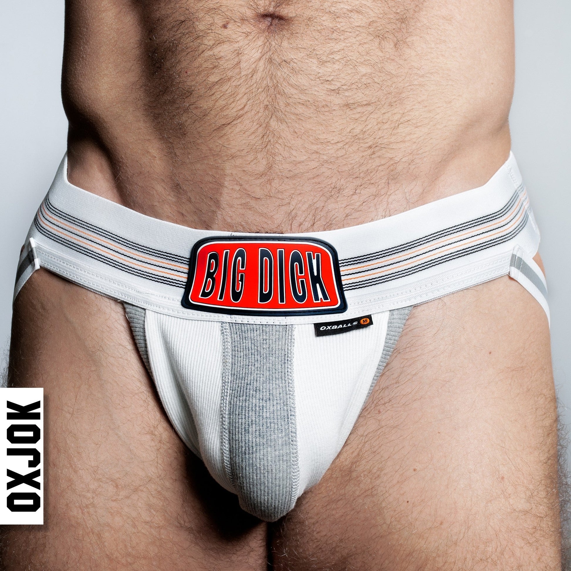 White jockstrap with "BIG DIGK" logo and grey stripes.