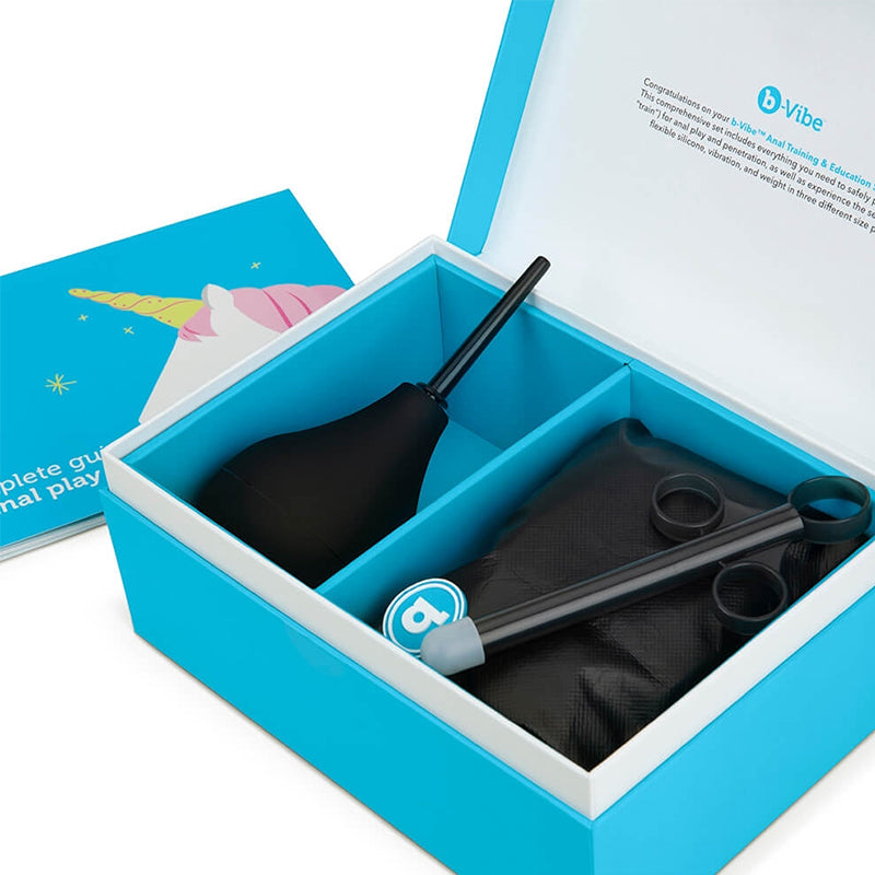 Anal training kit with enema bulb, silicone plugs, and guide in a blue box.