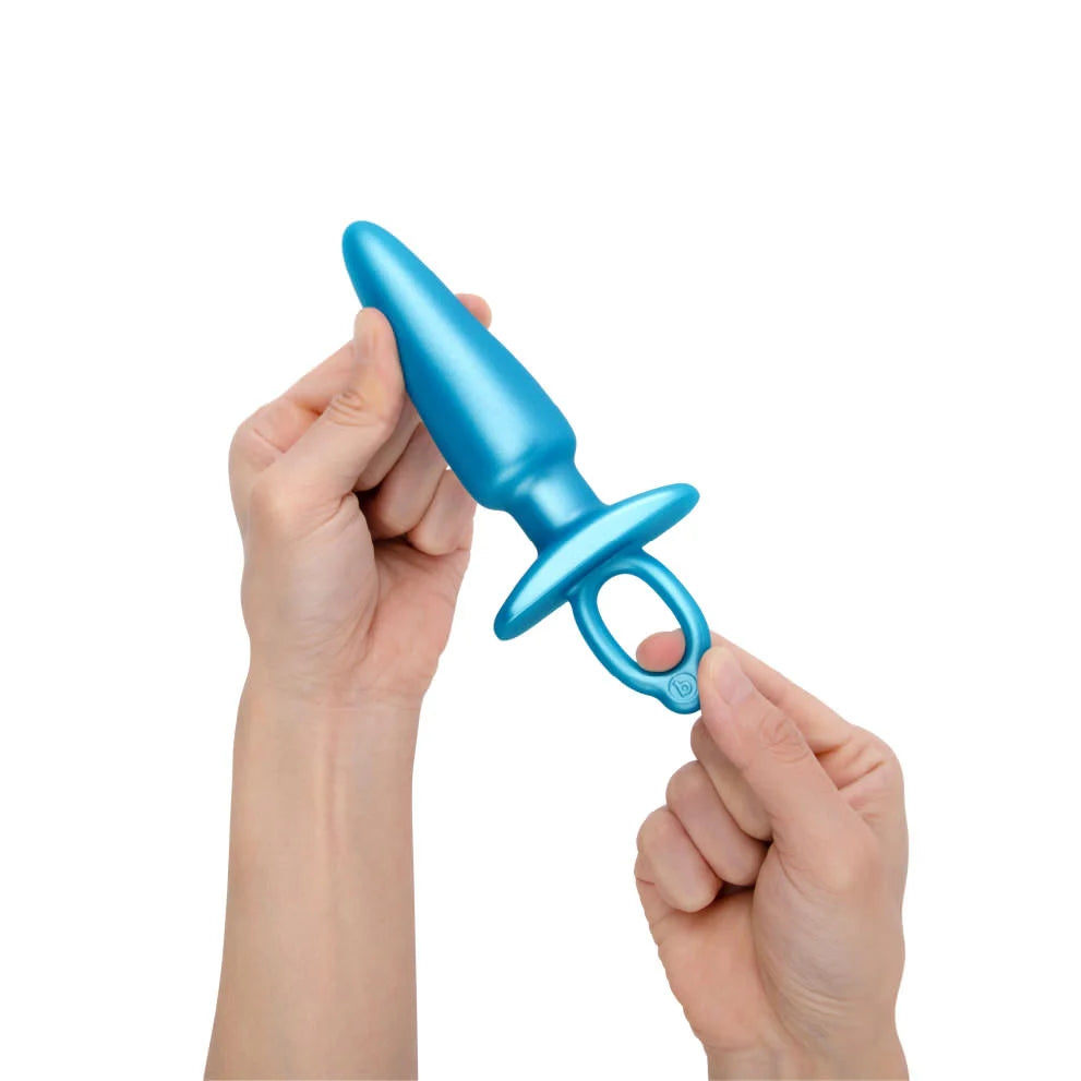 Blue silicone anal training plug with a tapered tip and a ring handle.