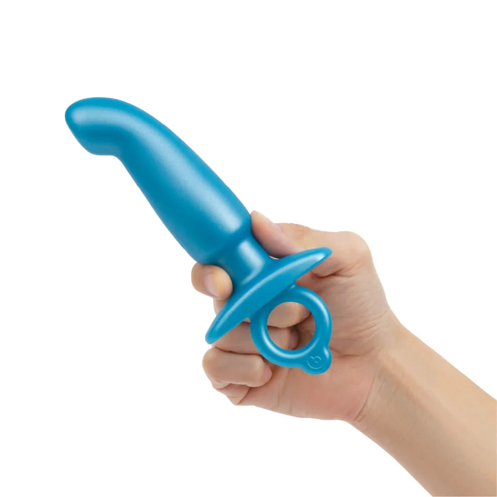 A blue silicone prostate plug with a retrieval ring held in a hand.