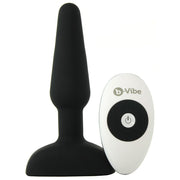 A black vibrating anal plug with a white remote control.