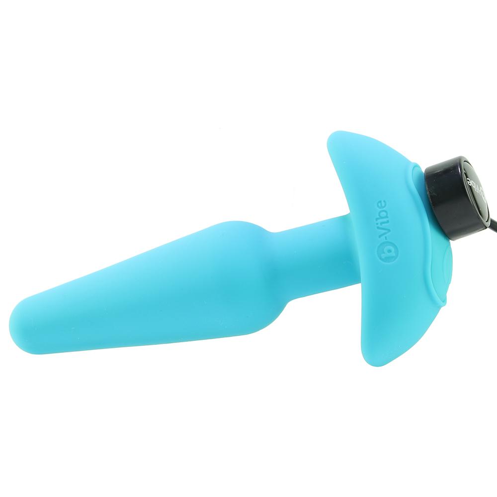 A blue silicone butt plug with a black cap and b-Vibe logo.