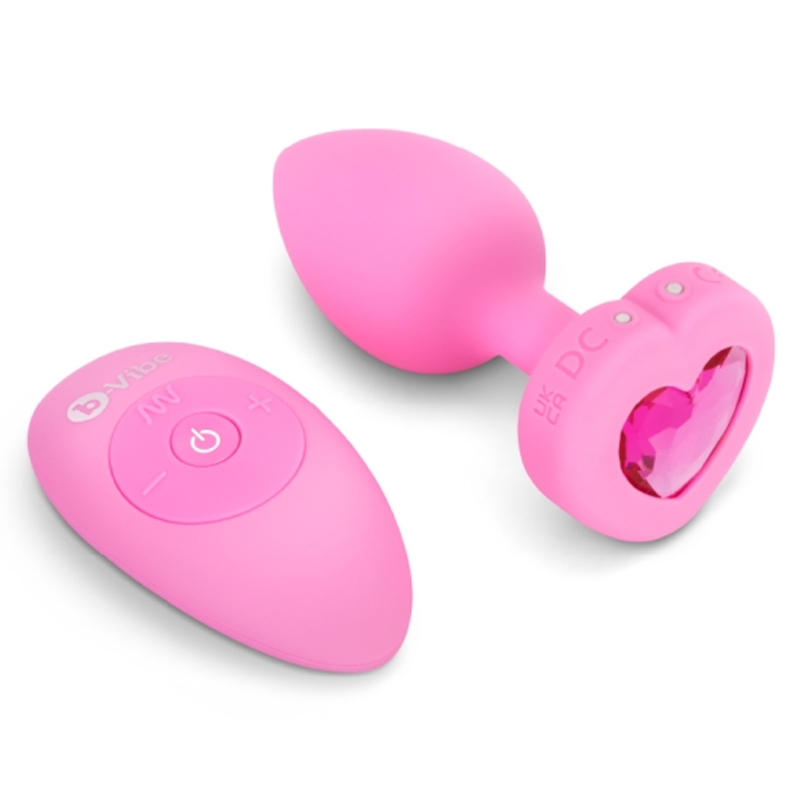 Pink silicone vibrating anal plug with heart-shaped jewel and remote control.