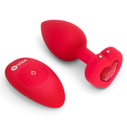 Red silicone vibrating anal plug with a heart-shaped jewel and remote control.