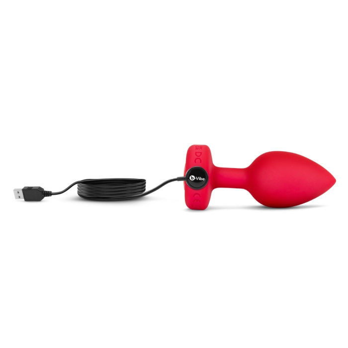 Red silicone vibrating anal plug with USB charging cable.