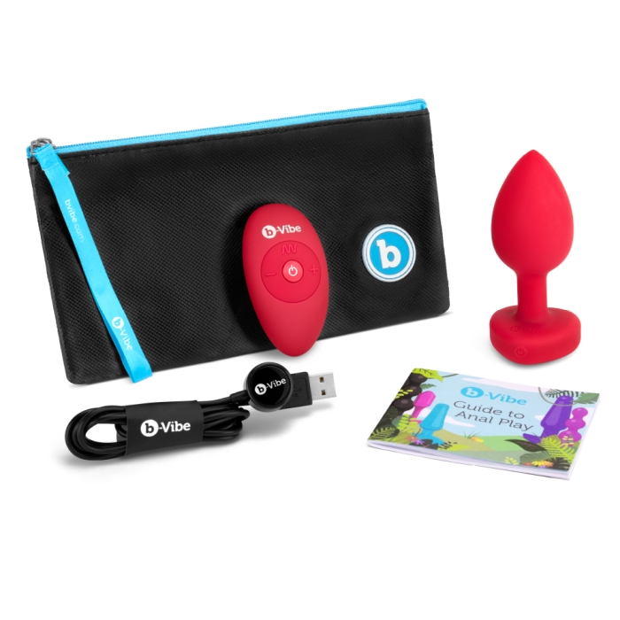 Red silicone anal plug with remote, charging cable, and guide.