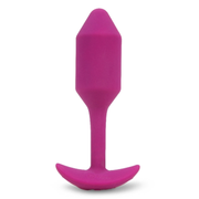 A rose-colored silicone vibrating snug plug with a flared base.