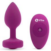 Fuchsia silicone vibrating anal plug and remote control.