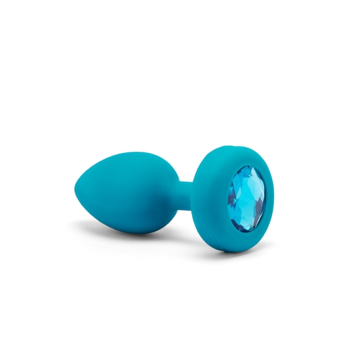 Teal silicone anal plug with a blue jewel accent.