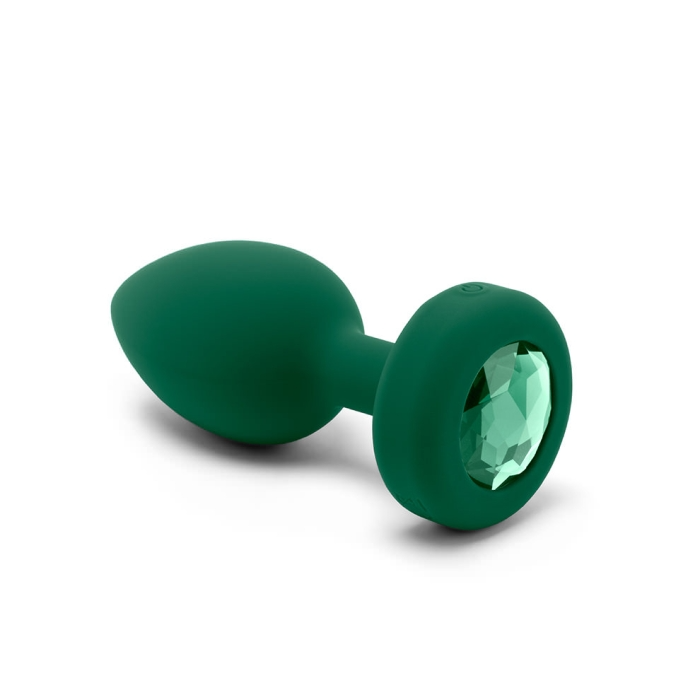 A green silicone anal plug with a faceted jewel accent.