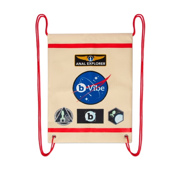 A beige drawstring bag with red trim and space-themed patches.