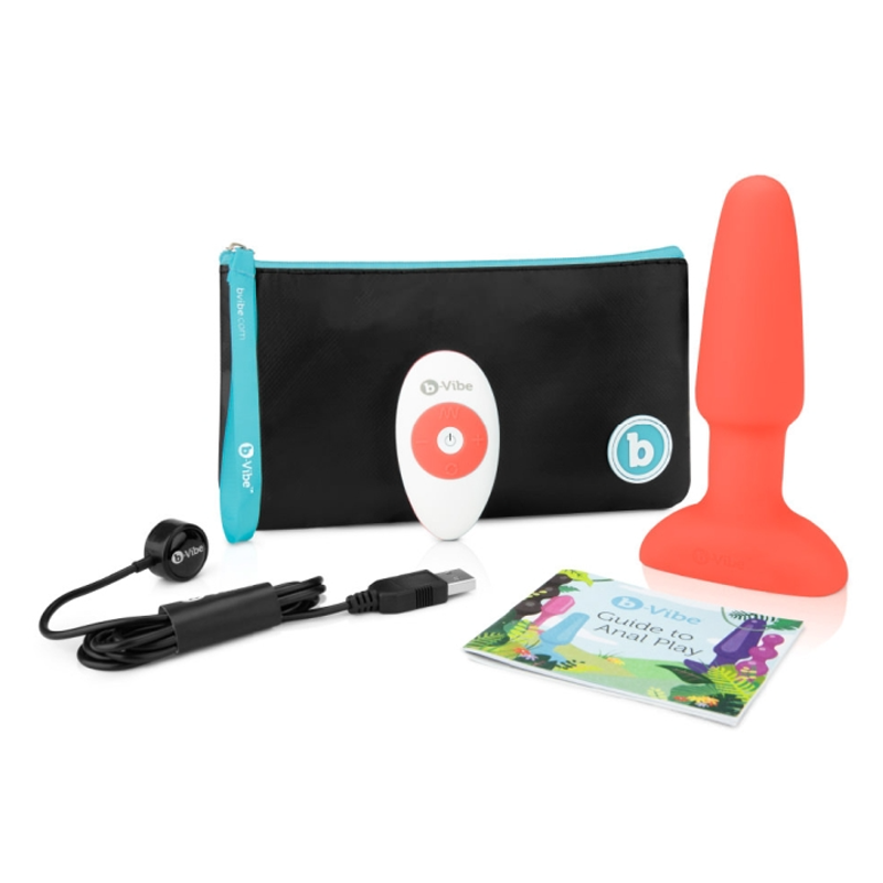 A red anal plug with a remote, charging cable, and instruction booklet.