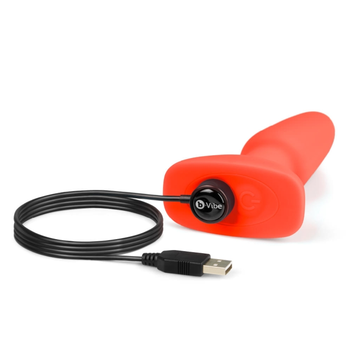 A red vibrating rimming plug with a USB charging cable.