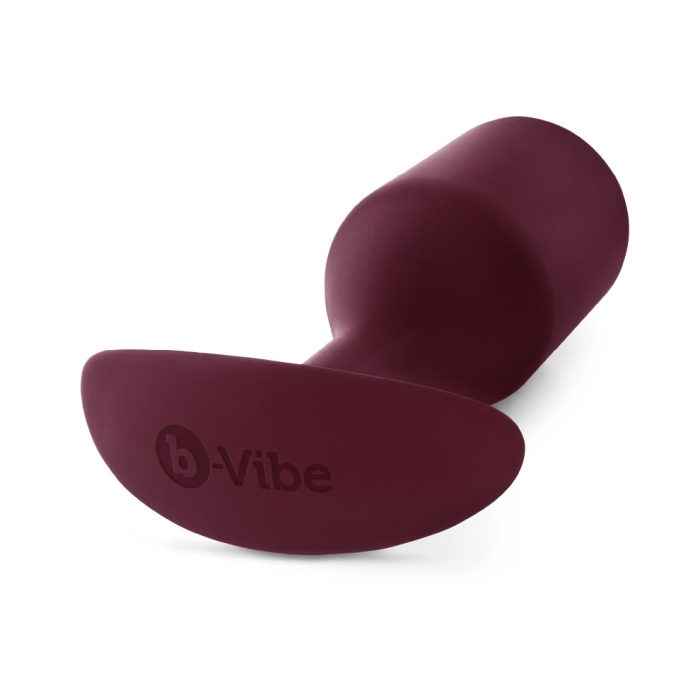 Dark red weighted silicone anal butt plug with a flared base.