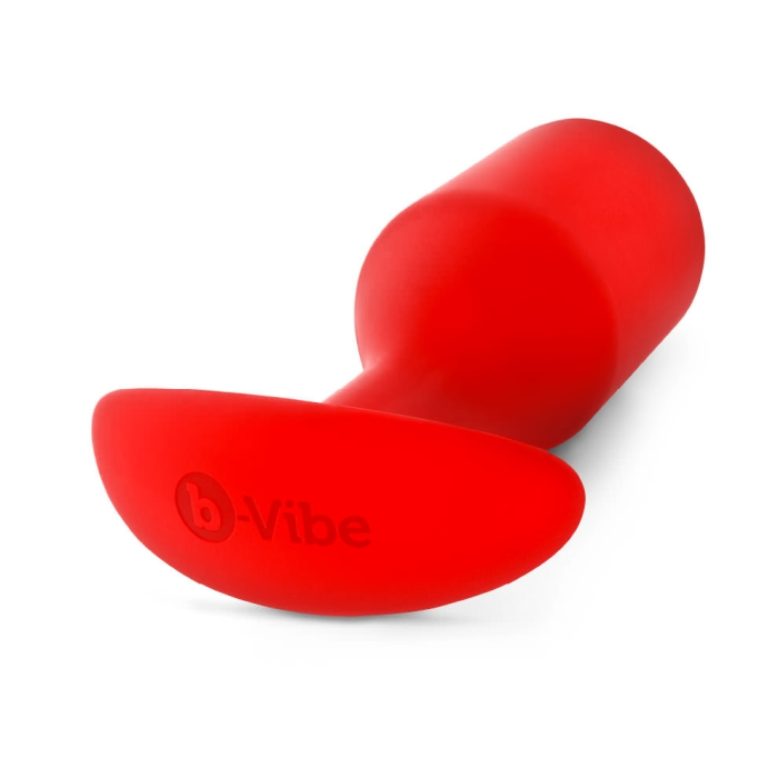 A red silicone anal plug with a tapered tip and a T-shaped base, featuring the b-Vibe logo.