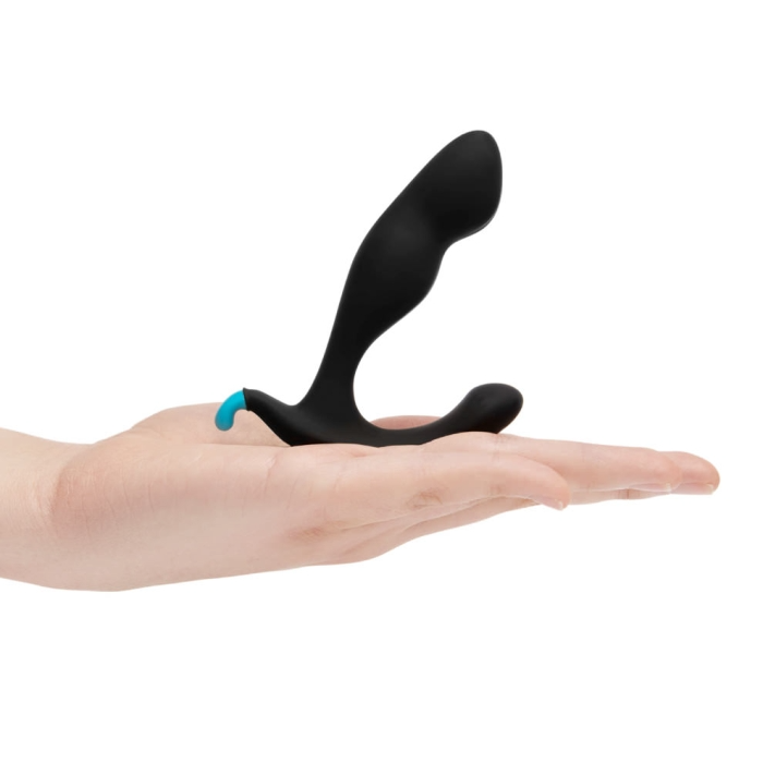 Black silicone prostate massager with a blue tip rests on a hand.