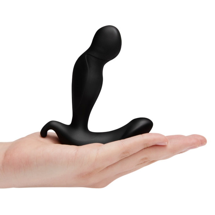 Black silicone prostate plug with a curved design held in a hand.