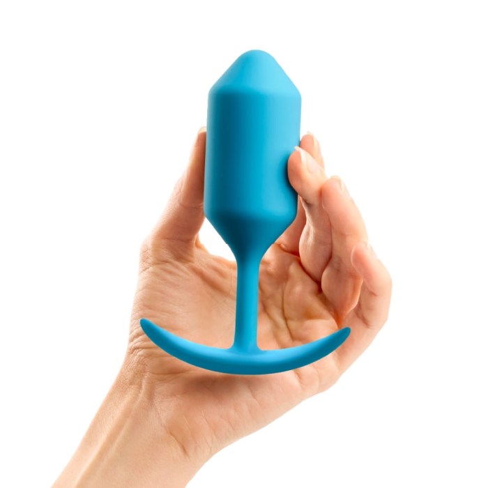 Teal weighted silicone anal plug held in a hand.