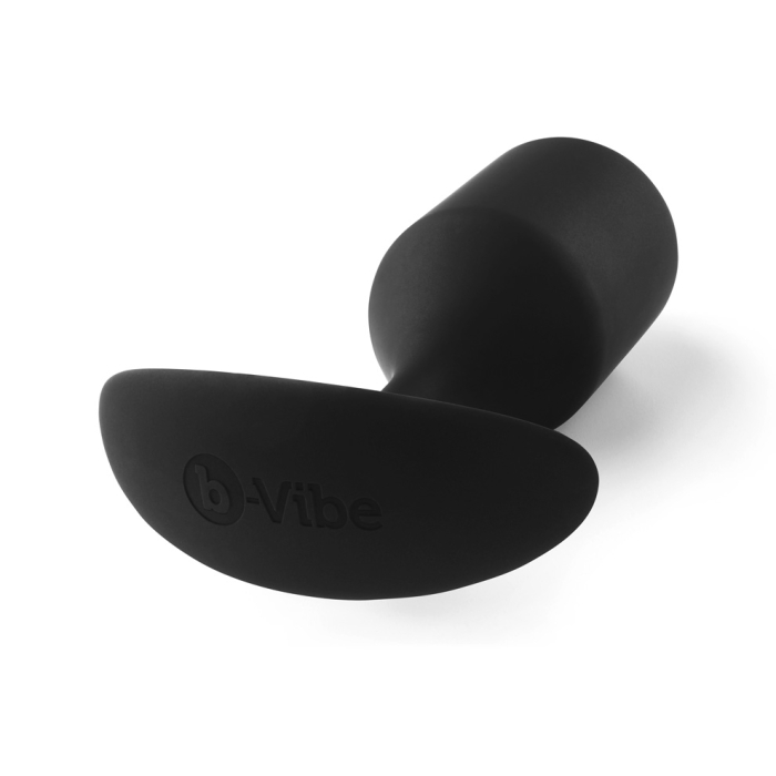 A black weighted silicone anal plug with a flared base and the b-Vibe logo.