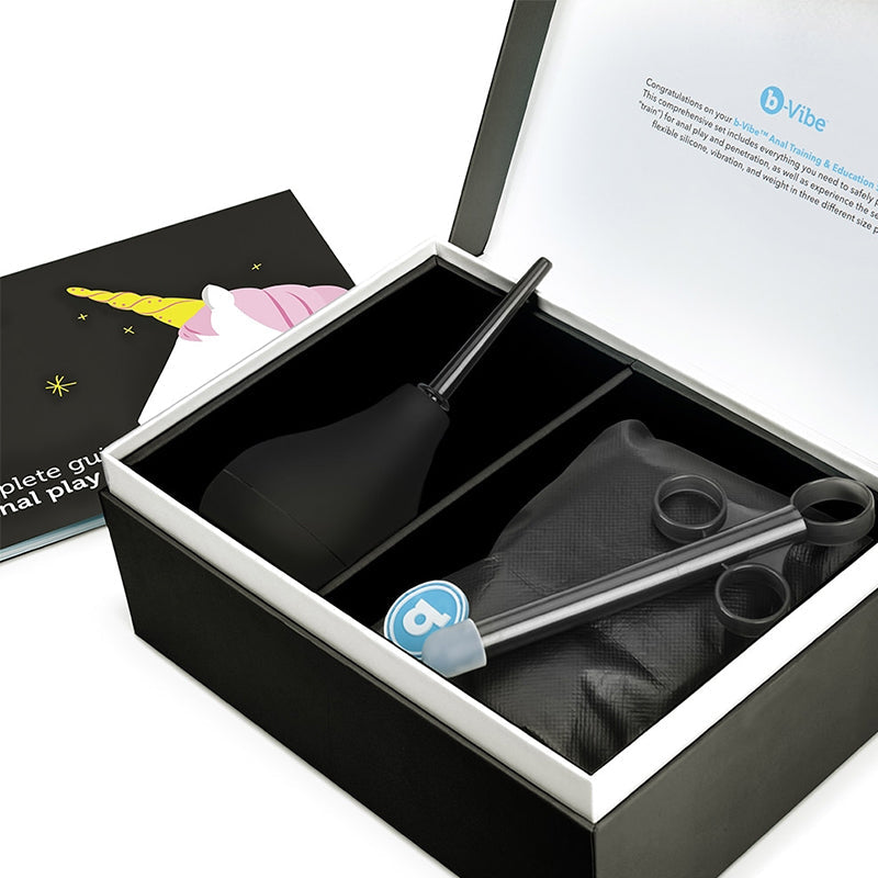 A black anal training kit with a unicorn-themed guide and a black enema bulb.