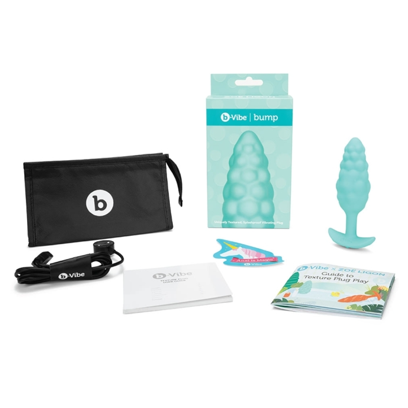 A teal b-Vibe Bump vibrating anal plug with a storage bag and instructions.