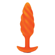 Orange silicone anal plug with a swirl texture and flared base.