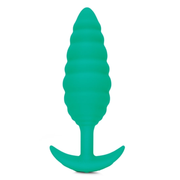 A green silicone anal plug with a ribbed texture and a flared base.